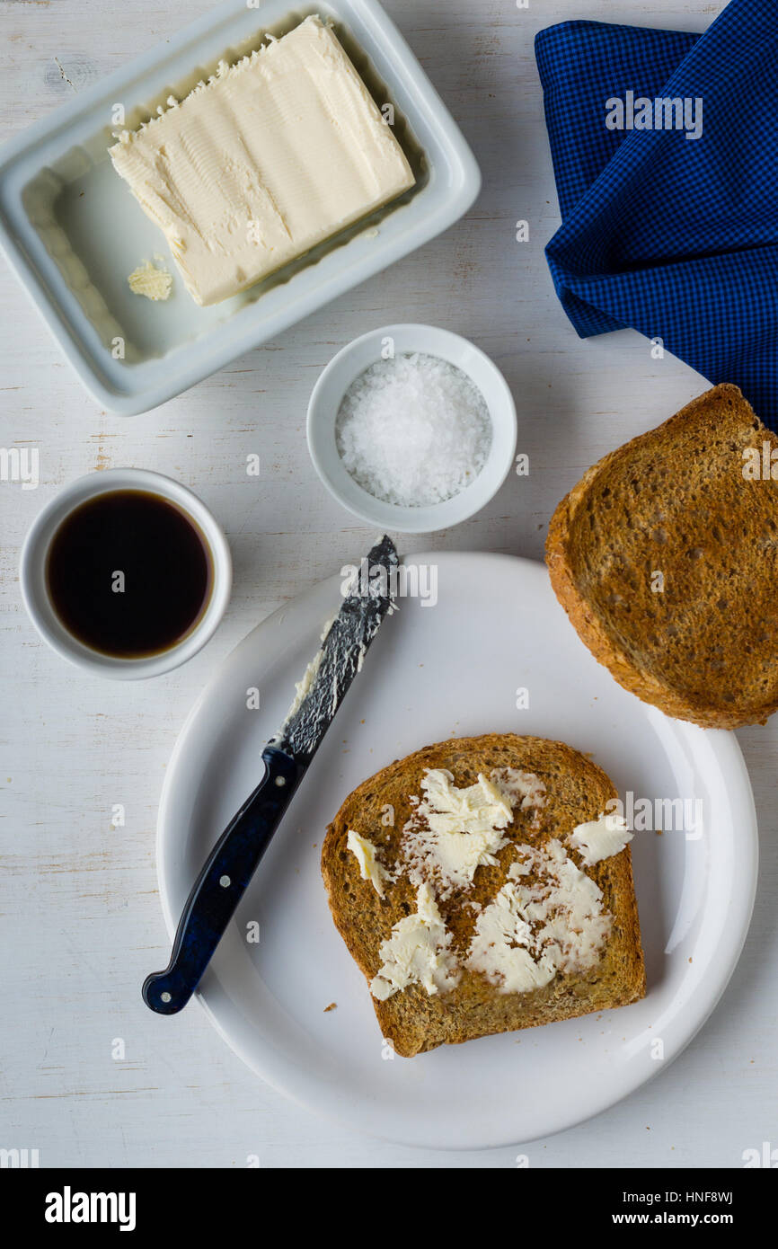 overhead shot of toast and butter breakfast with coffe on white table Stock Photo