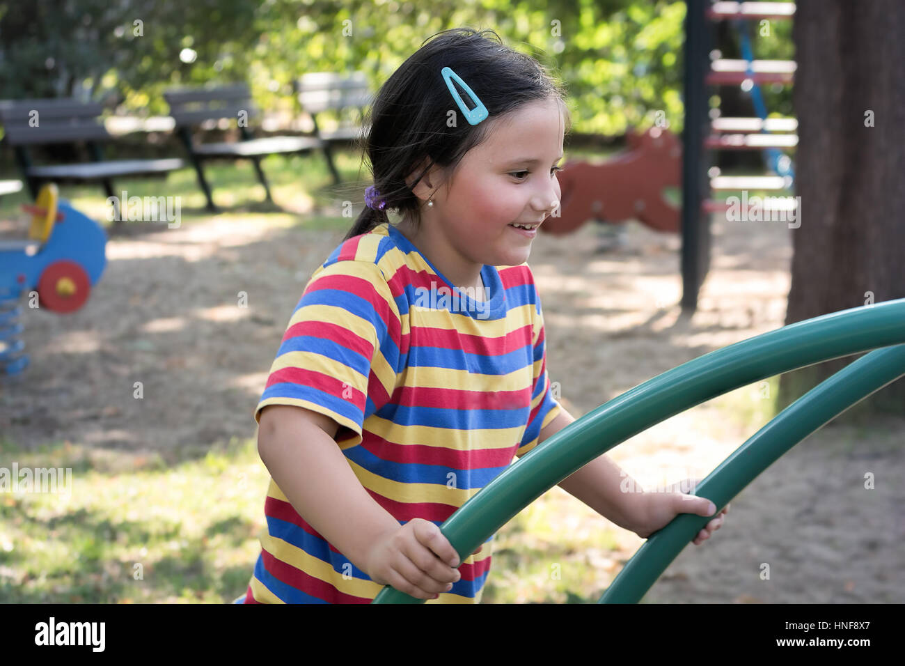 Happy child, little girl playing in a playground Stock Photo - Alamy