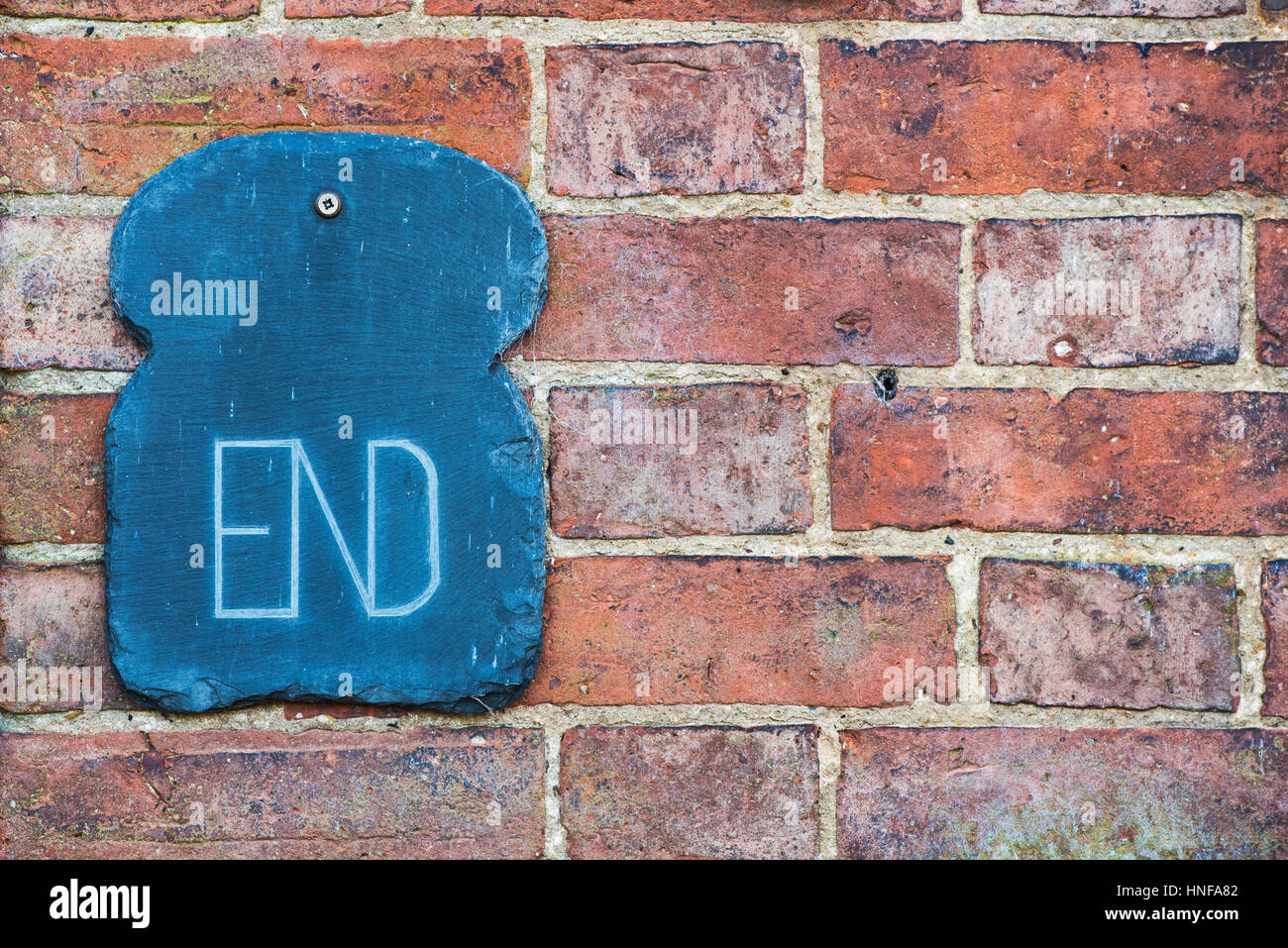 END Slate house sign on a red brick wall. UK Stock Photo