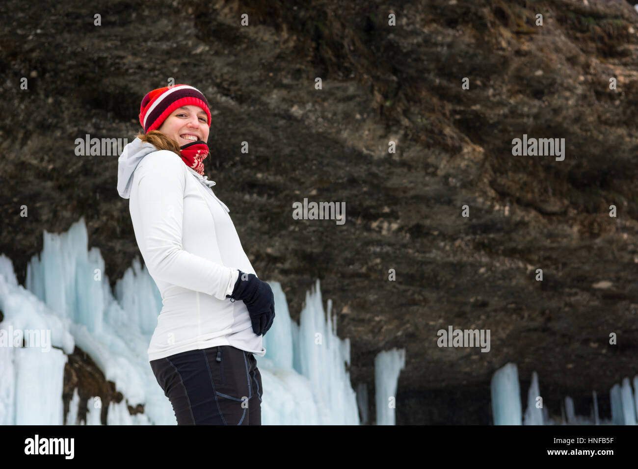 Young pregnant woman smiling on winter landscape. Stock Photo