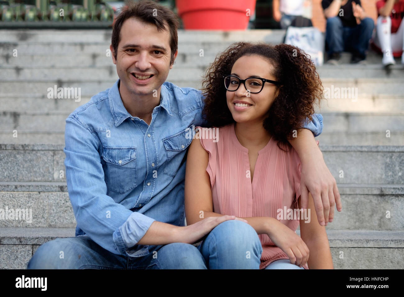 Romantic interracial couple embraced in the city Stock Photo