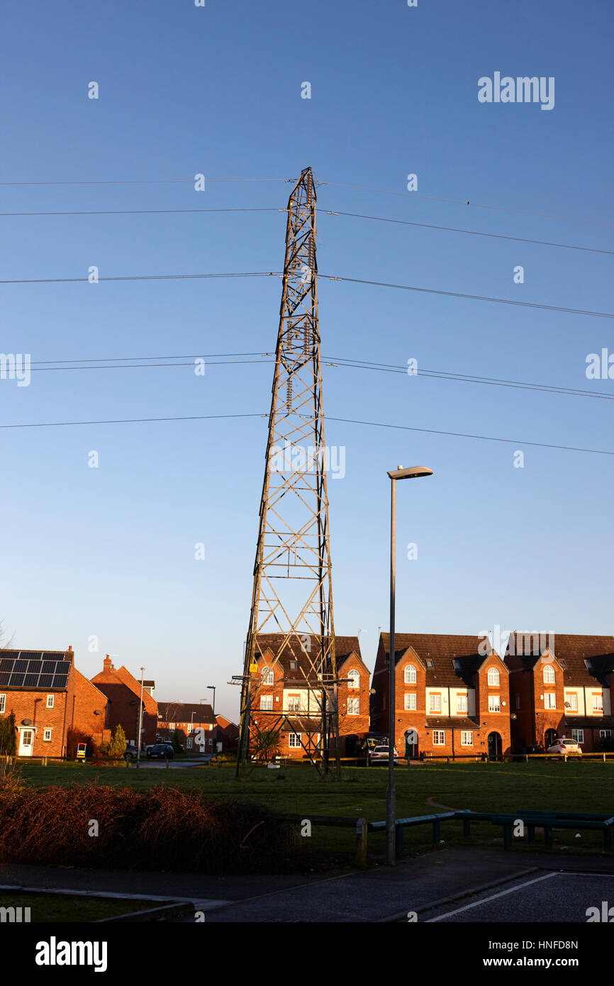 electricity transmission tower cutting through housing estate in kirkby liverpool uk Stock Photo