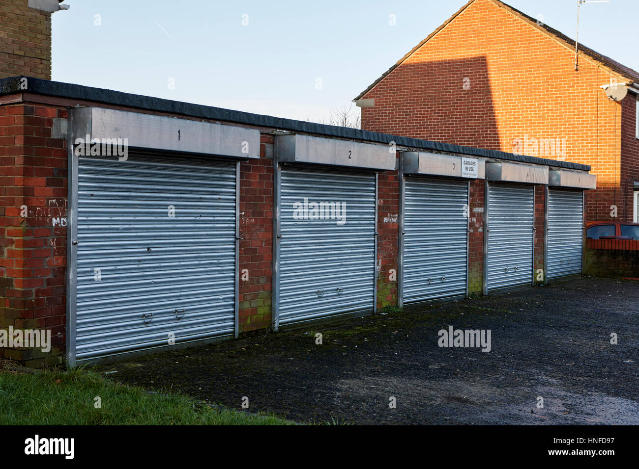 row of small garages on a housing estate in kirkby liverpool uk Stock Photo