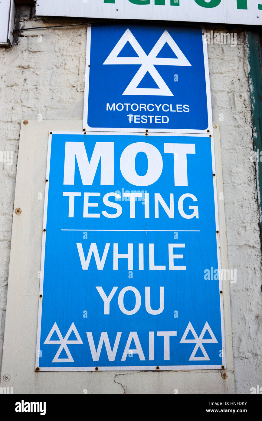 mot testing sign centre while you wait motorcycles tested signs uk Stock Photo