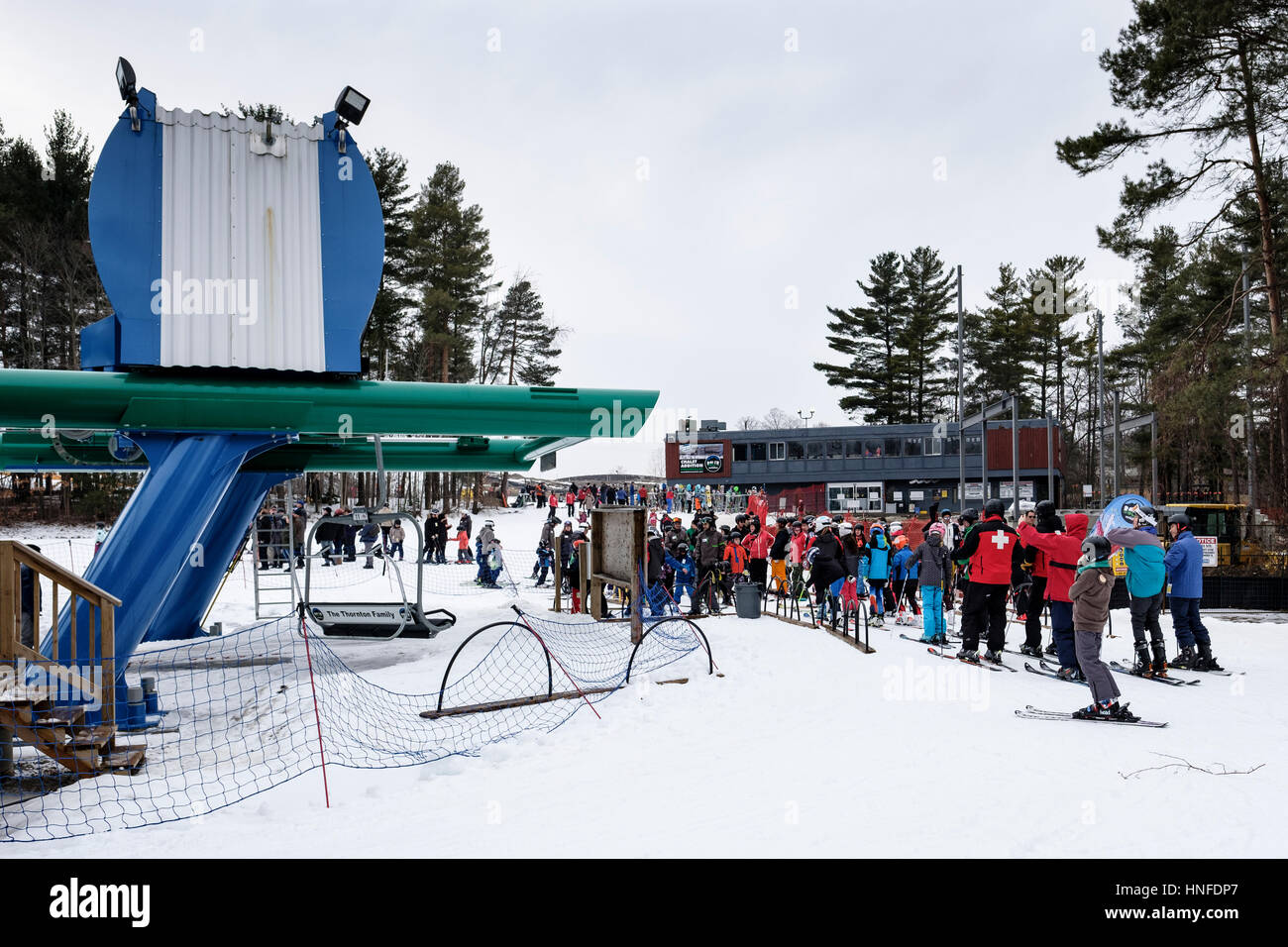Lineup of skiers waiting for a ski lift at Boler Mountain Ski Club in London, Ontario, Canada. Stock Photo