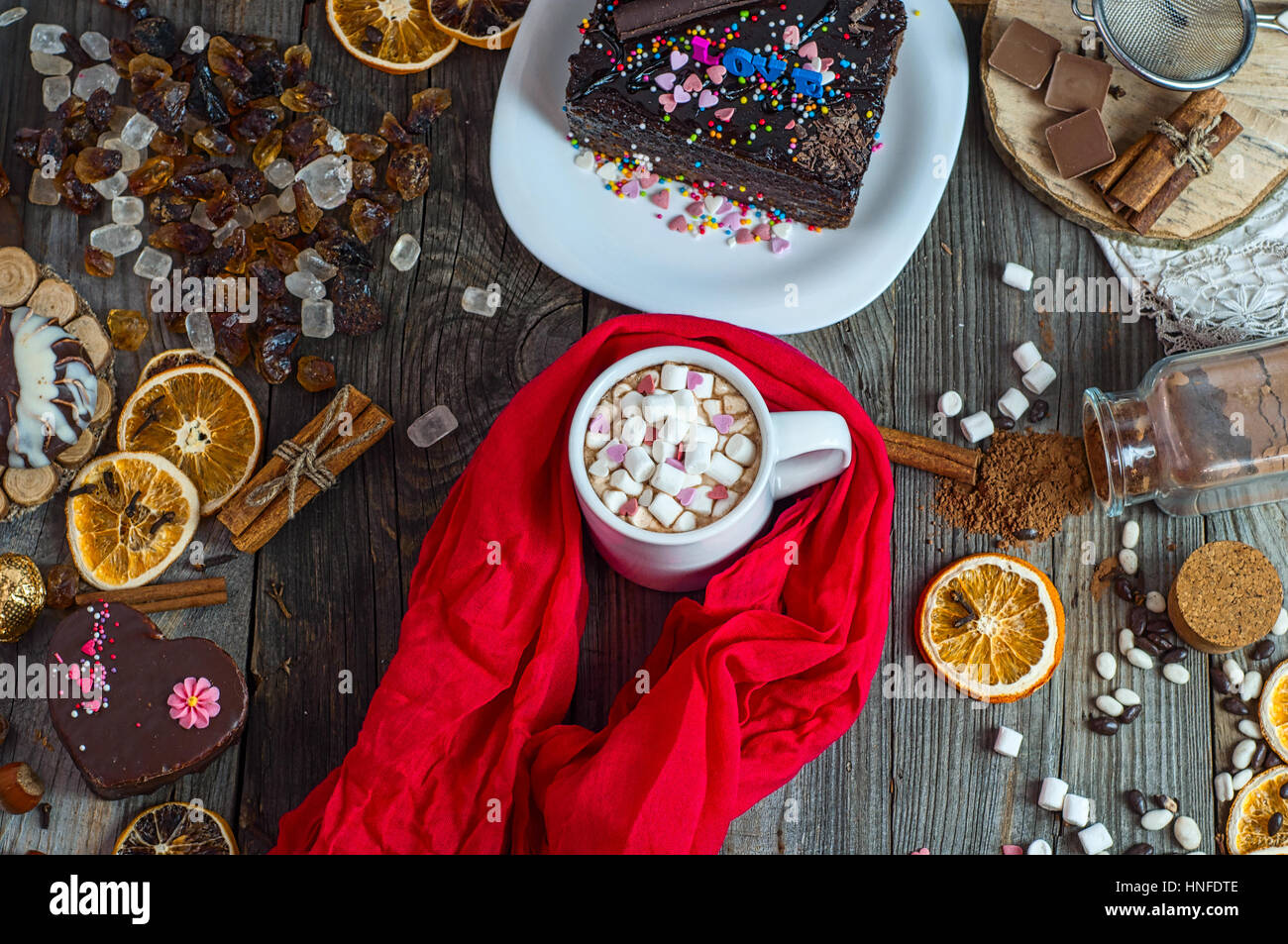 cup of chocolate drink with marshmallows wrapped in red textile scarf ...