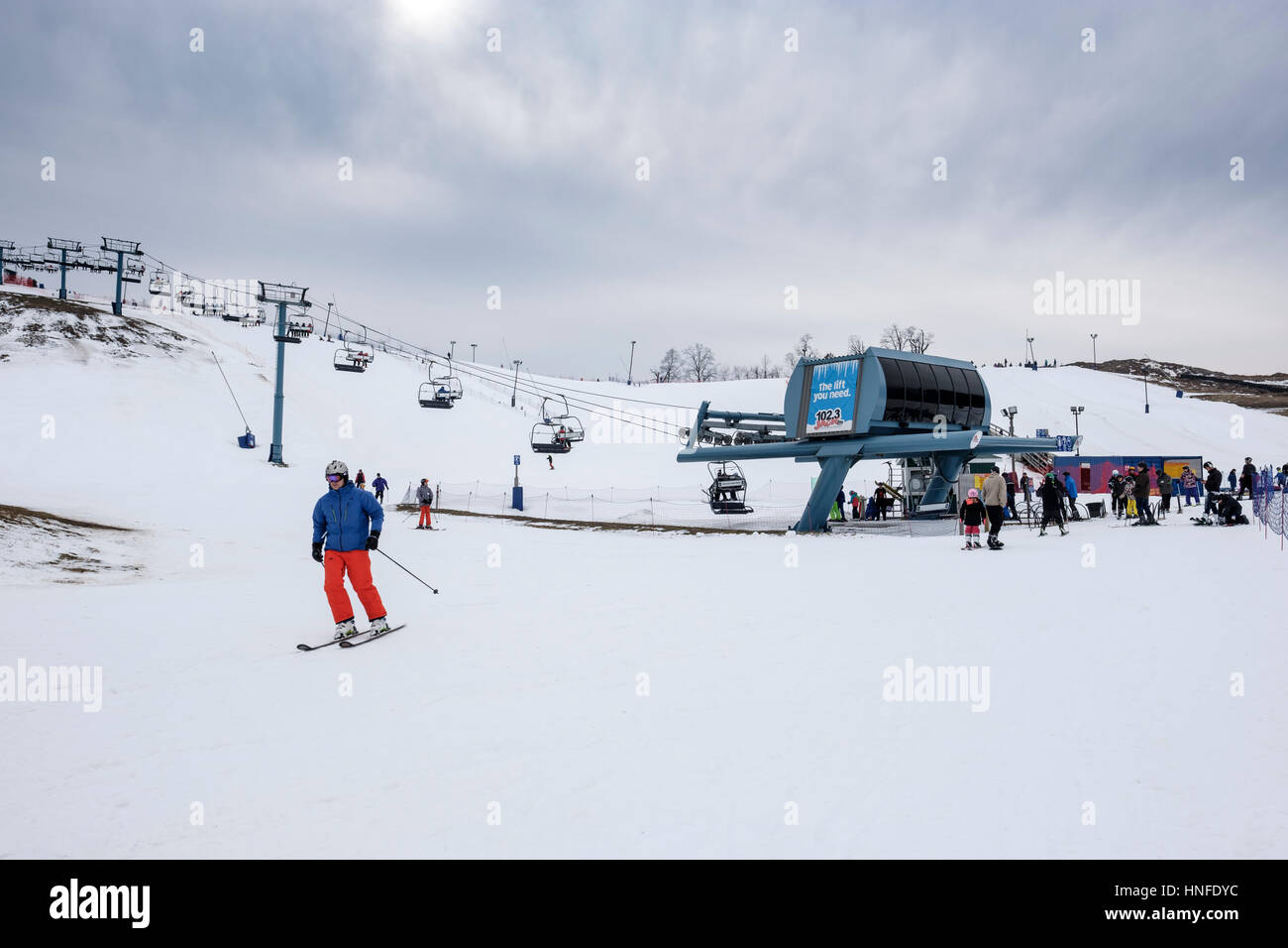 Lineup of skiers waiting for a ski lift at Boler Mountain Ski Club in London, Ontario, Canada. Stock Photo