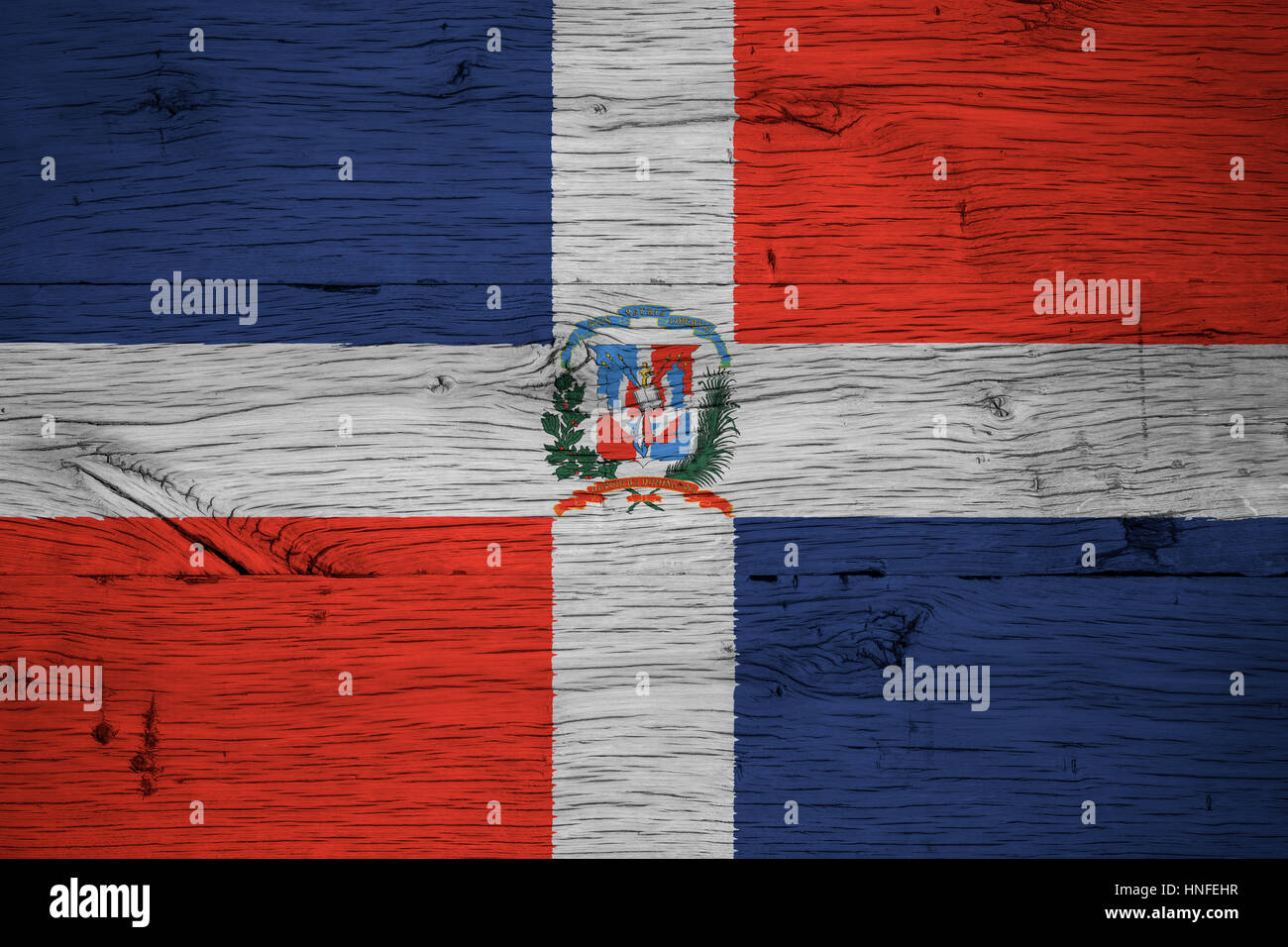 Dominican Republic national flag with coat of arms painted on old oak wood. Painting is colorful on planks of old train carriage. Stock Photo