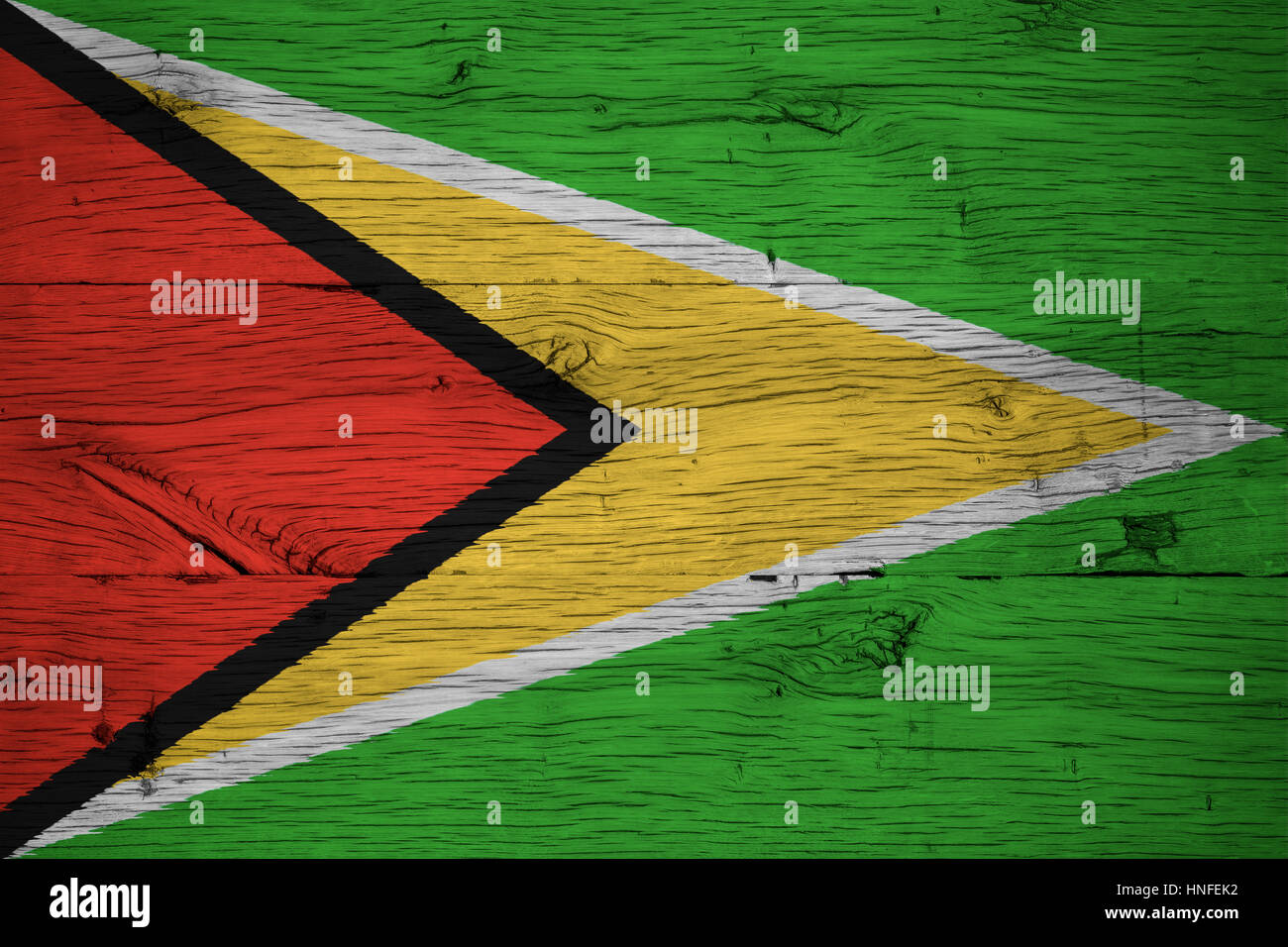 Guyana national flag painted on old oak wood. Painting is colorful on planks of old train carriage. Stock Photo
