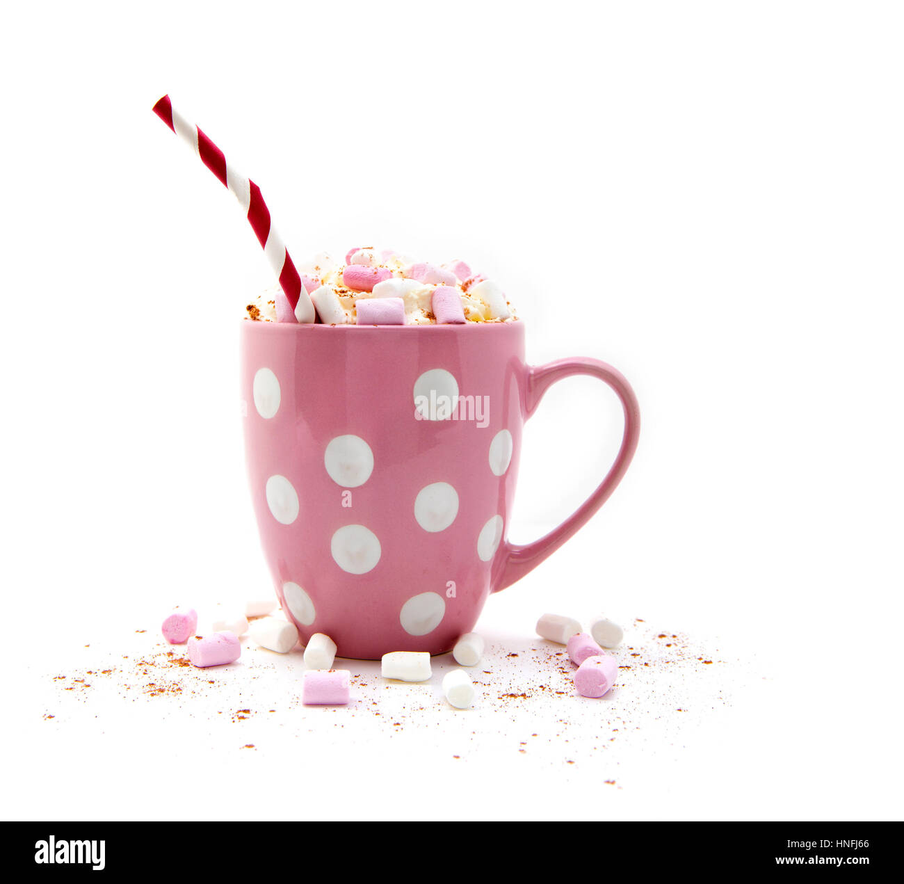 Hot Chocolate in a pink mug with marshmallows and a red and white striped straw on a white background Stock Photo