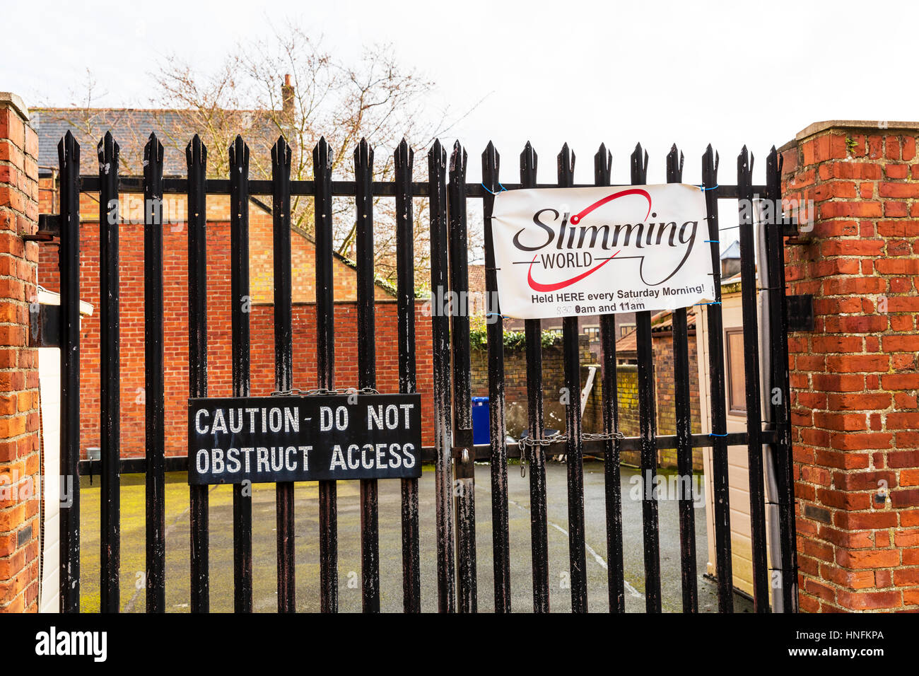 Funny amusing signs together, slimming world caution do not obstruct access sign funny together wonder which one came first Stock Photo