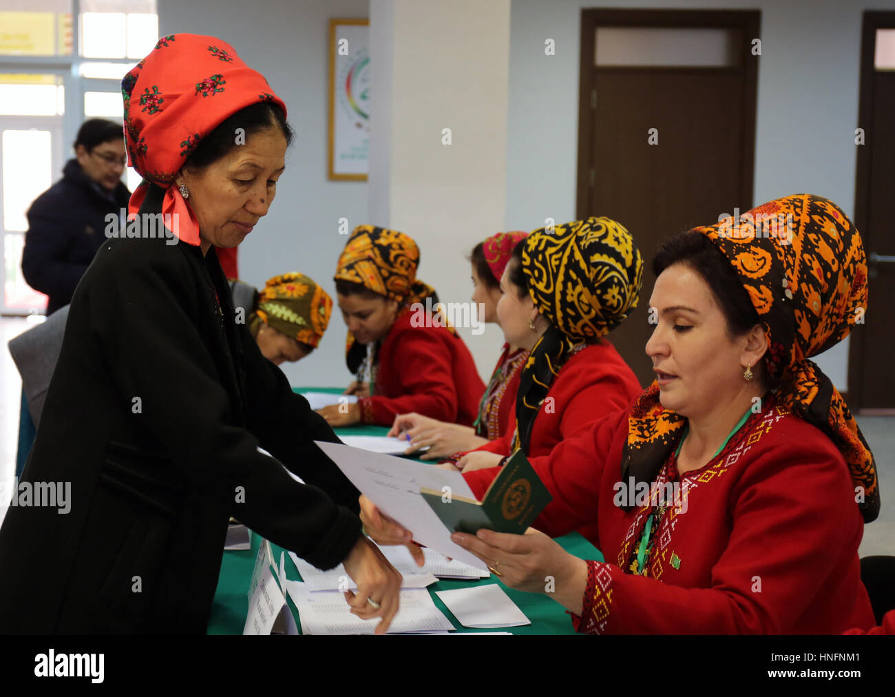 Ashgabad, Turkmenistan. 12th Feb, 2017. A Turkmen woman (L) prepares