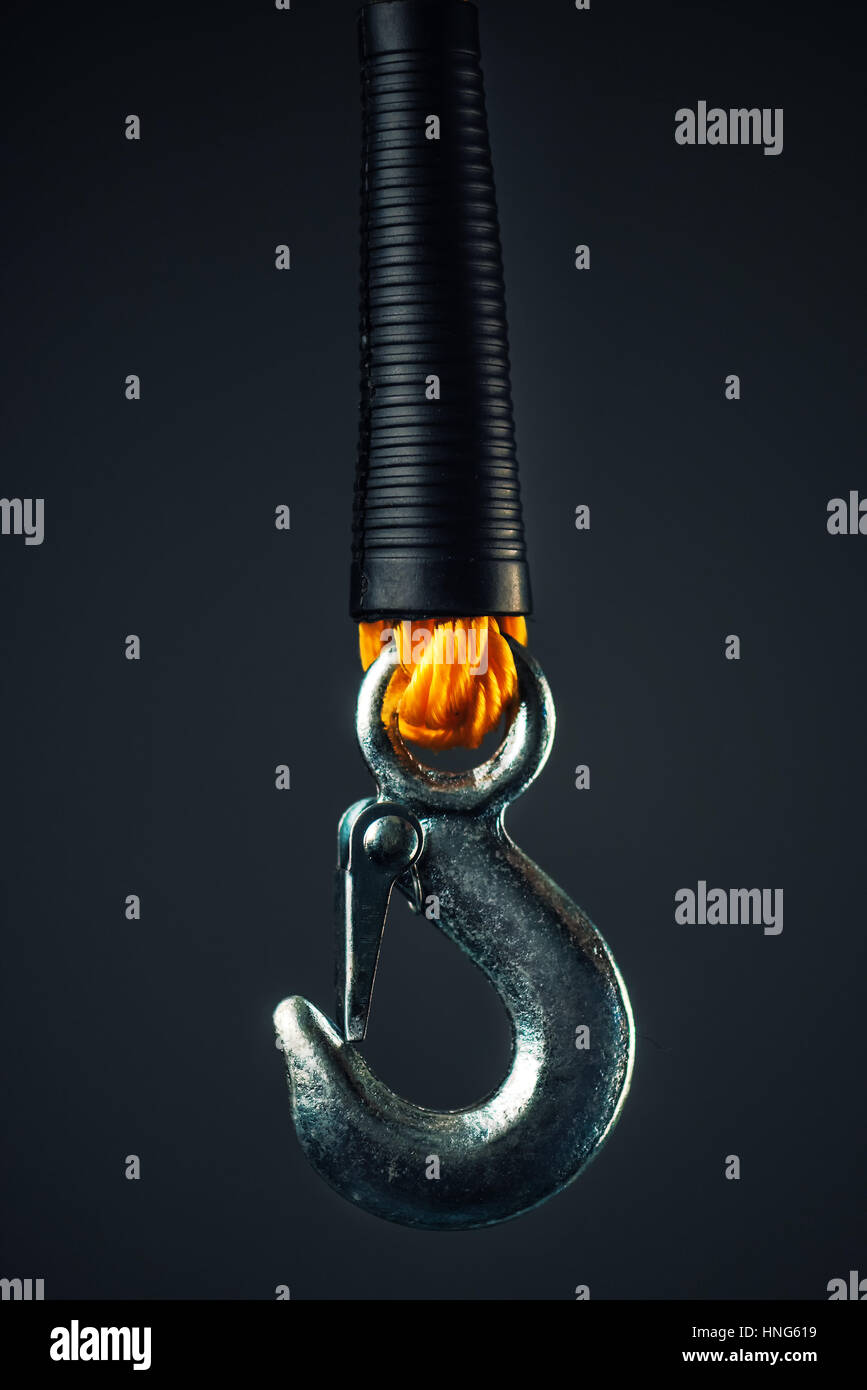 Chrome car hook and tow rope on dark background Stock Photo
