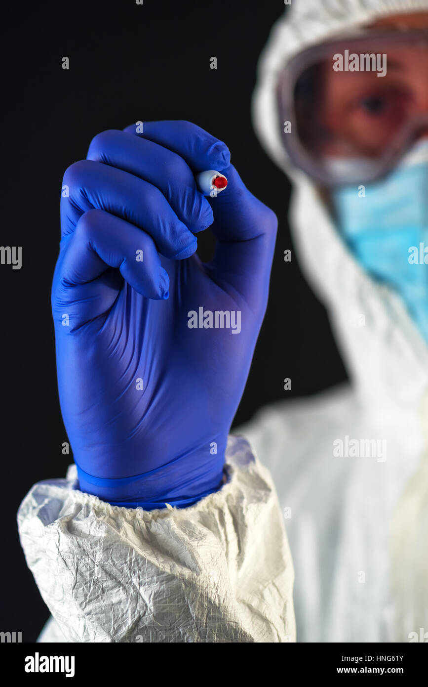 Scientist in protective clothes writing with red marker felt tip pen Stock Photo