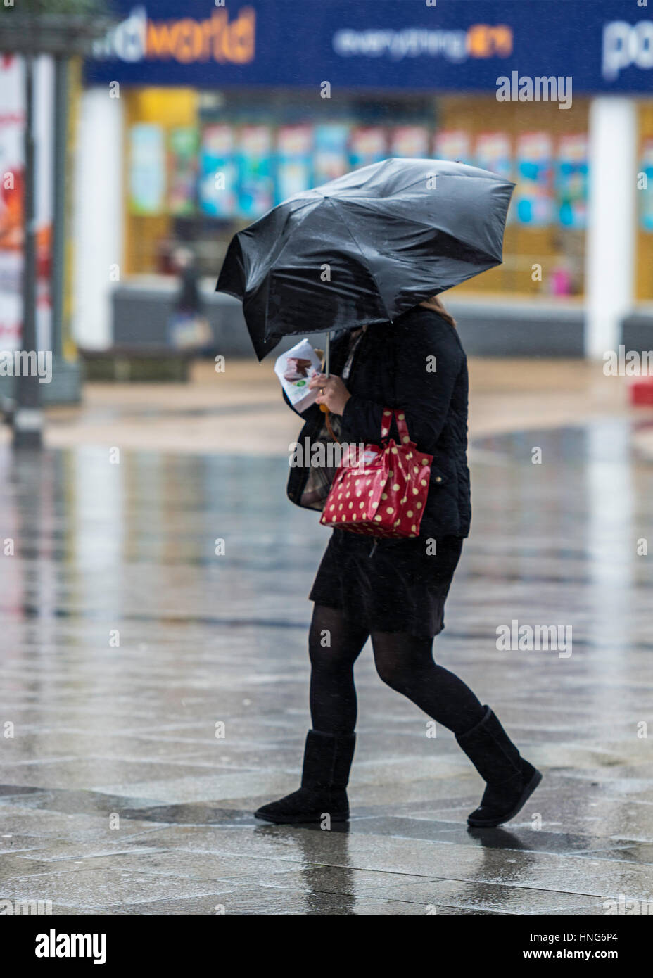 Struggling in the wind and rain in Plymouth city Center in the rain and wind. Stock Photo