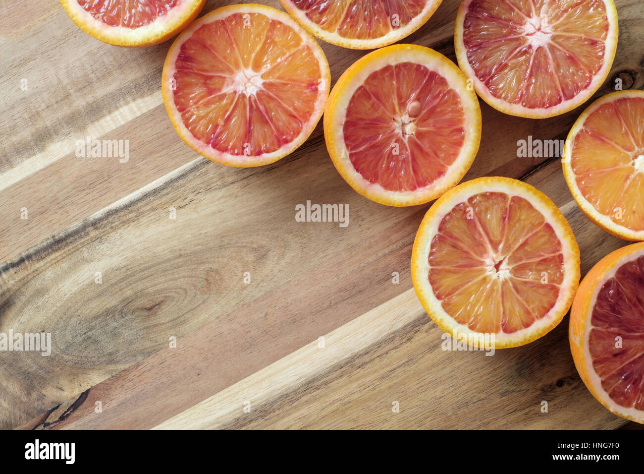 Fresh half cut oranges on wooden table - Copy space Stock Photo