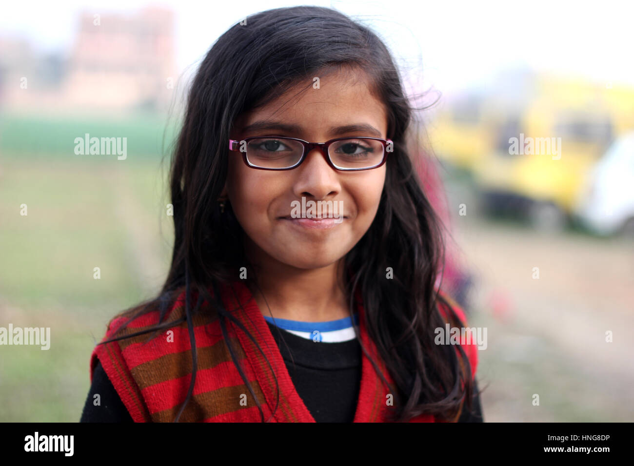 Indian young smiling female kid with spectacles Stock Photo