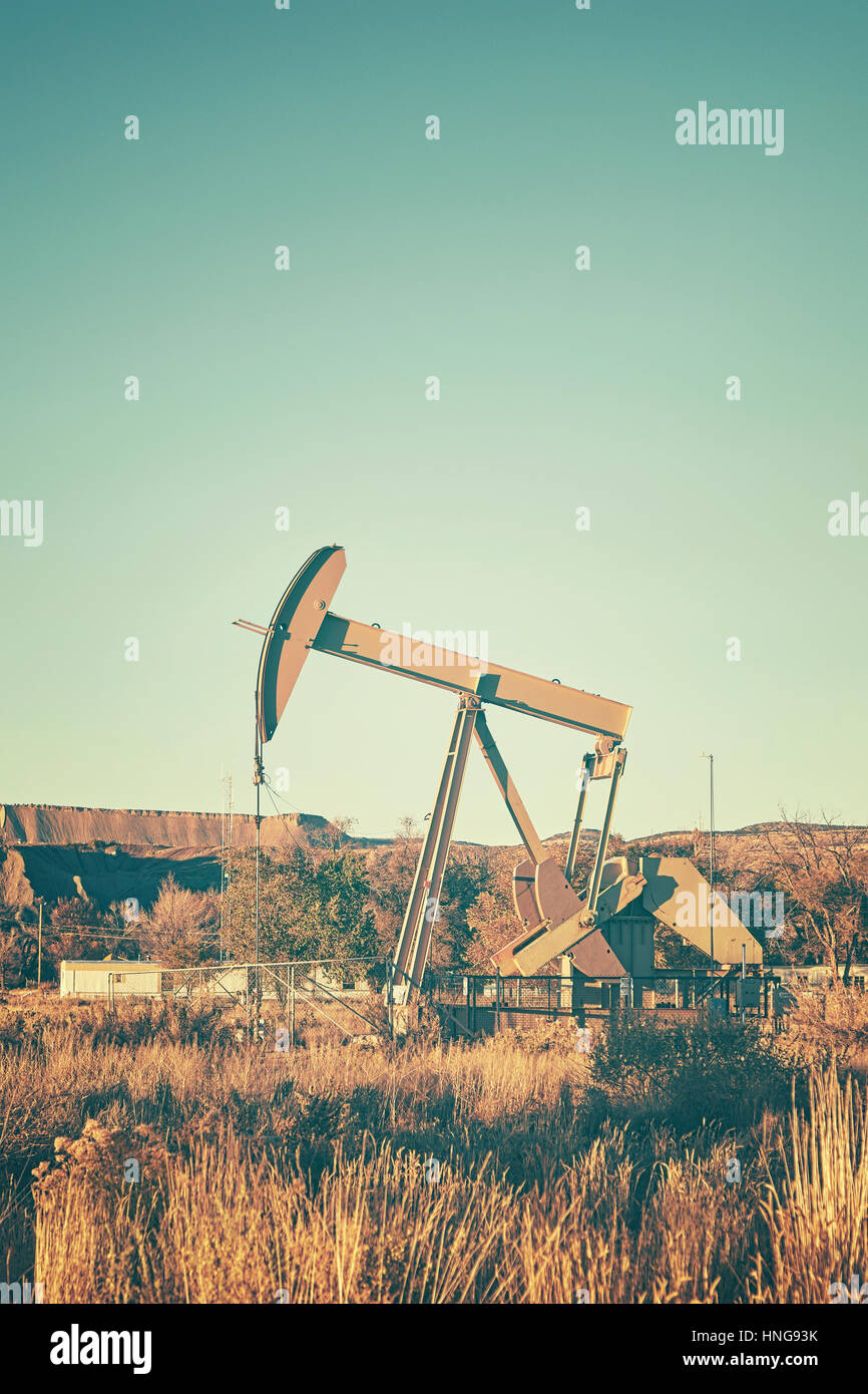 Retro stylized an old oil pump, industrial equipment, USA. Stock Photo