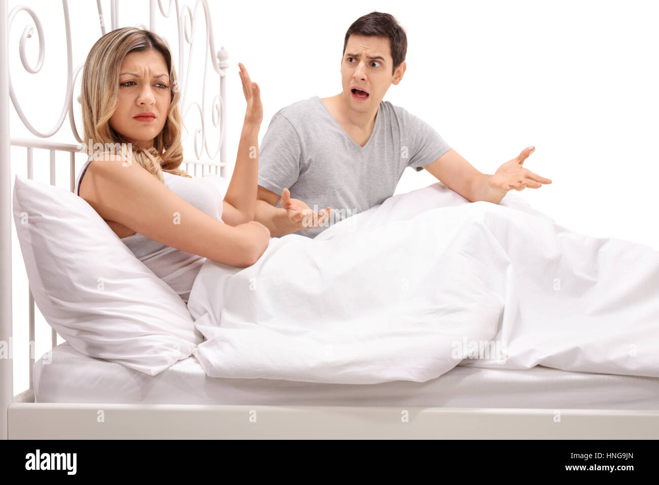 Young couple arguing in bed isolated on white background Stock Photo