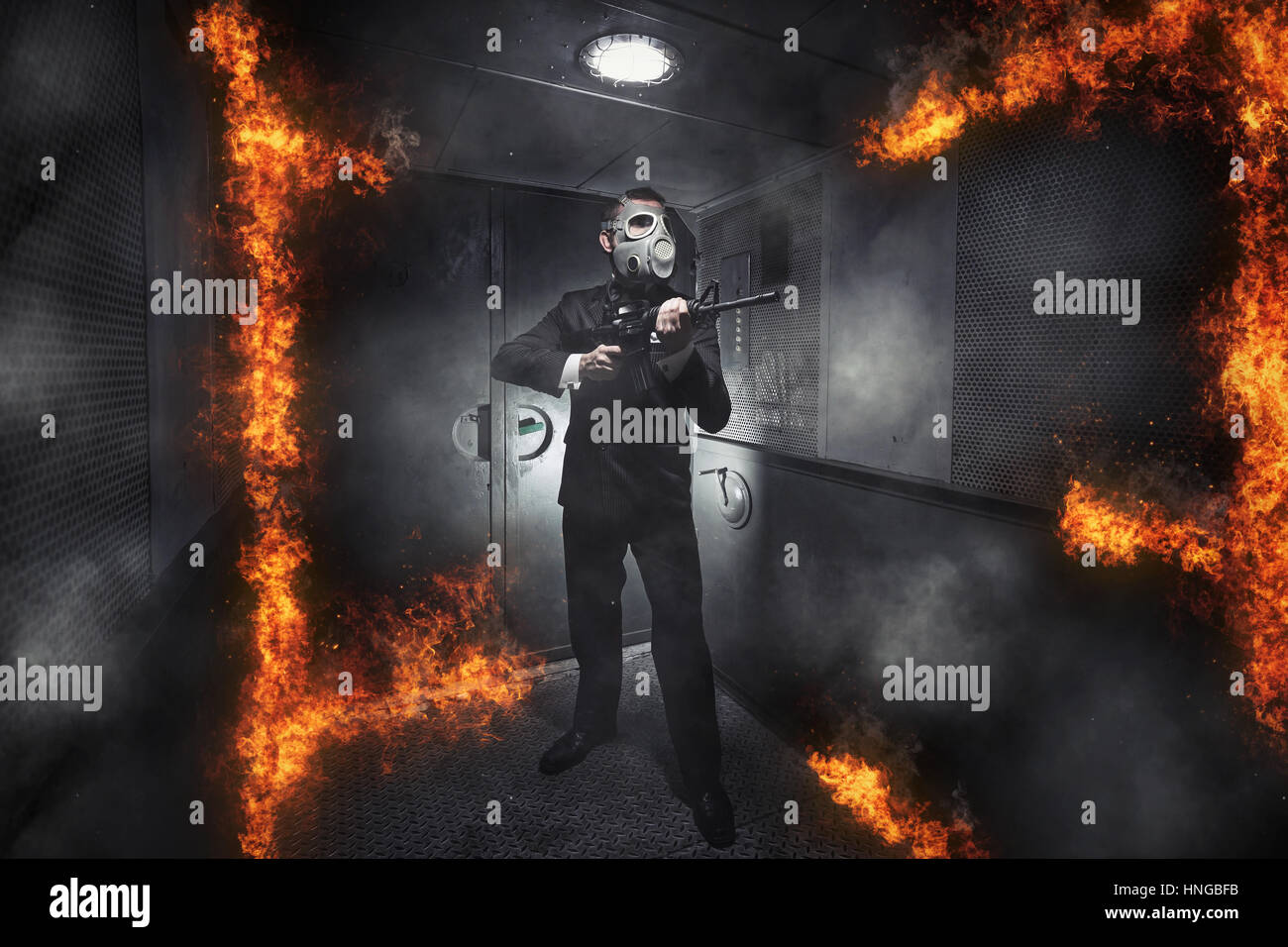 A man in a gas mask with a rifle in the old elevator Stock Photo