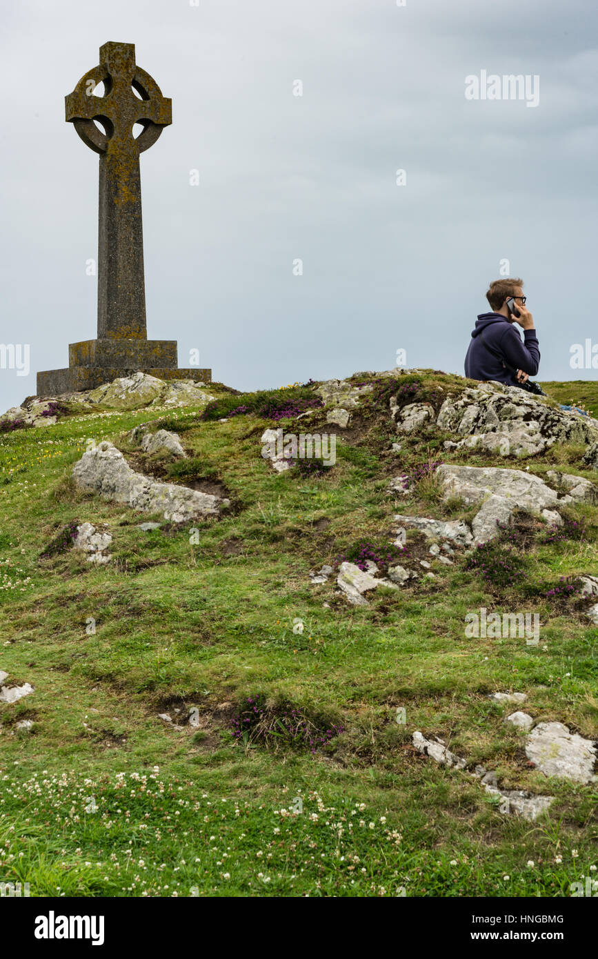 Modern life intrudes on a more ancient spiritual scene on Llanddwyn Island, Anglesey Stock Photo