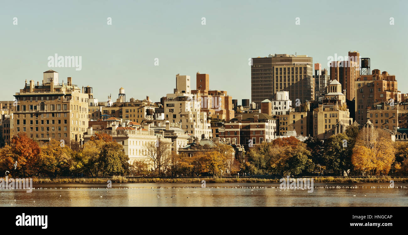 Central park Manhattan east side luxury building over lake in Autumn in New York City. Stock Photo