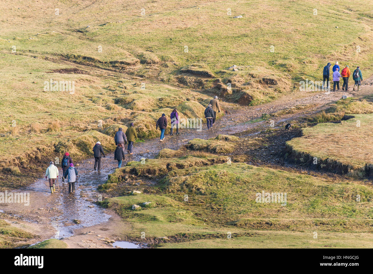 A group of walkers on Rough Tor, designated as an area of Outstanding Natural Beauty on Bodmin Moor in Cornwall. Stock Photo