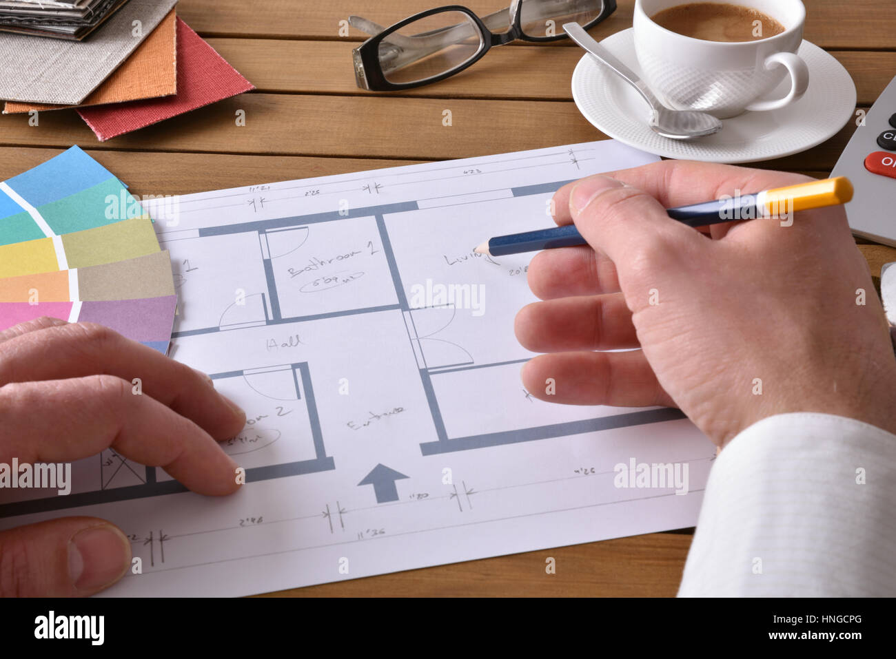 Designer working on an interior design project on wood table with a ...