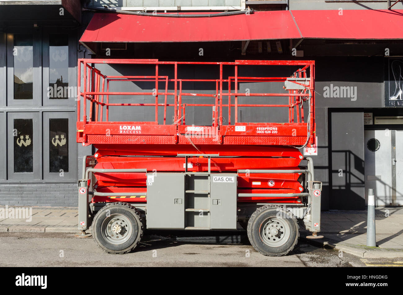 Red hydraulic platform parked in a road Stock Photo