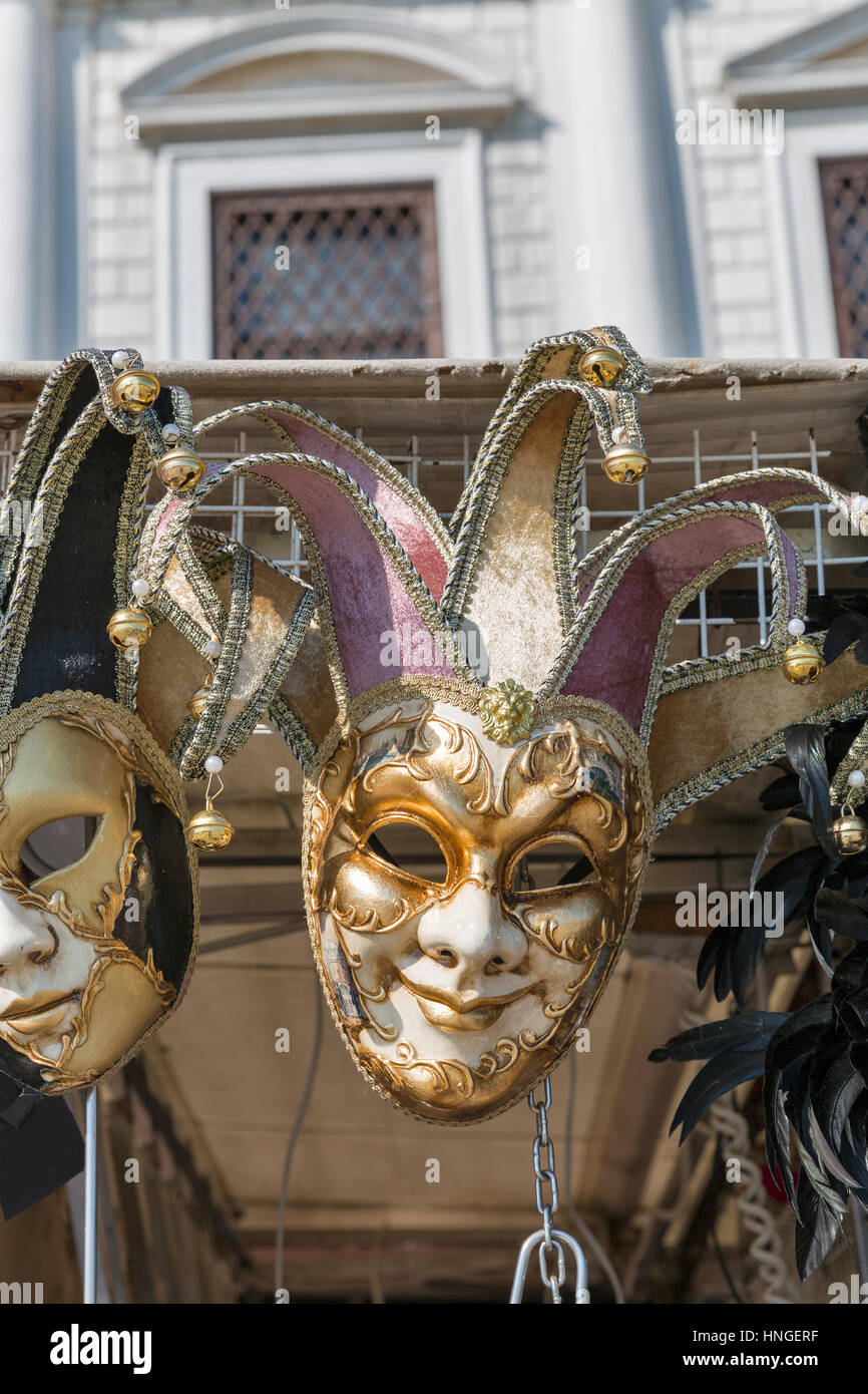 Closeup of Venetian carnival masks with beautiful decoration on display for sale outdoor in front of Doge Palace in Venice, Italy. Stock Photo
