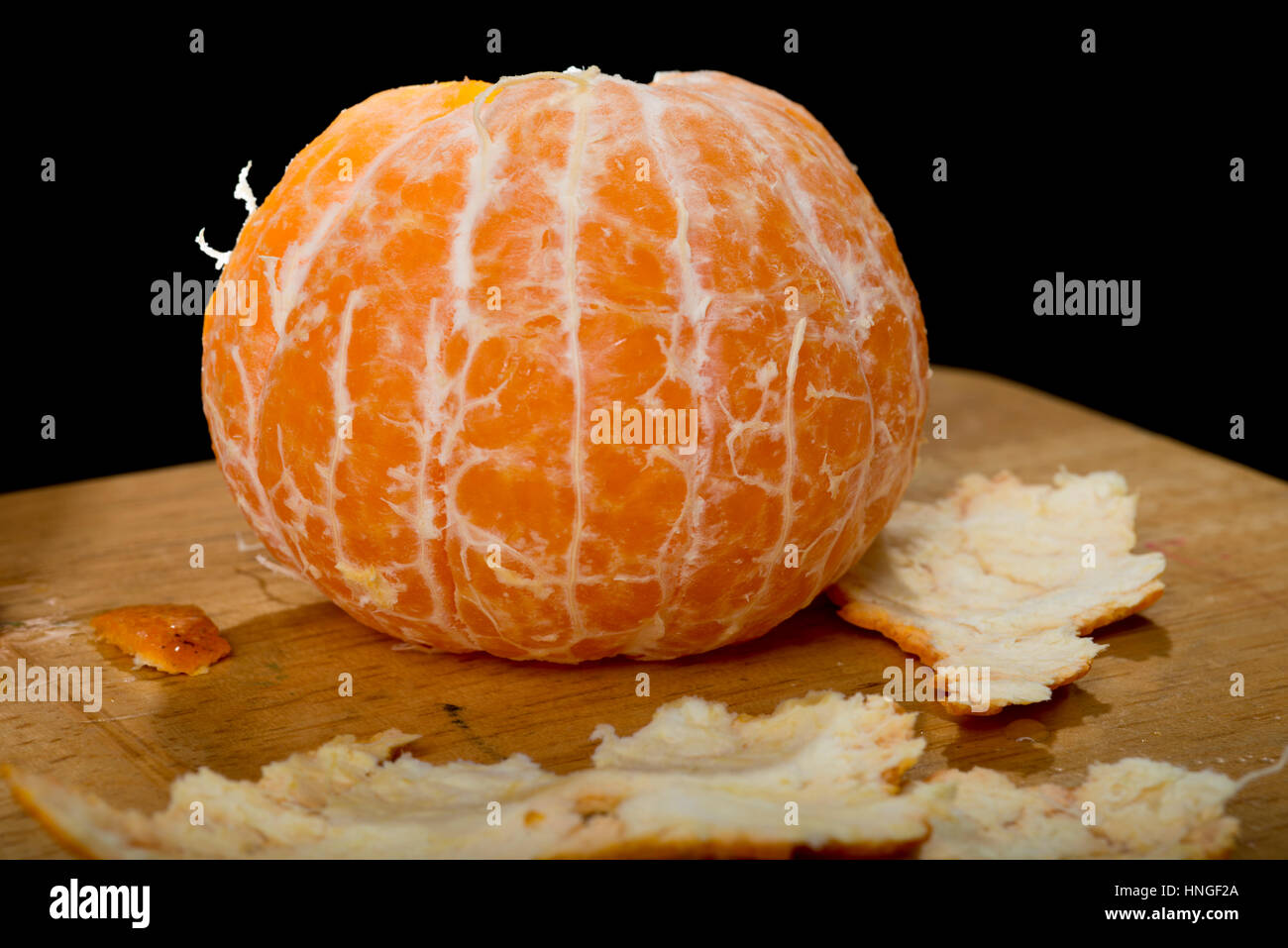 peeled tangerine with peelings Stock Photo