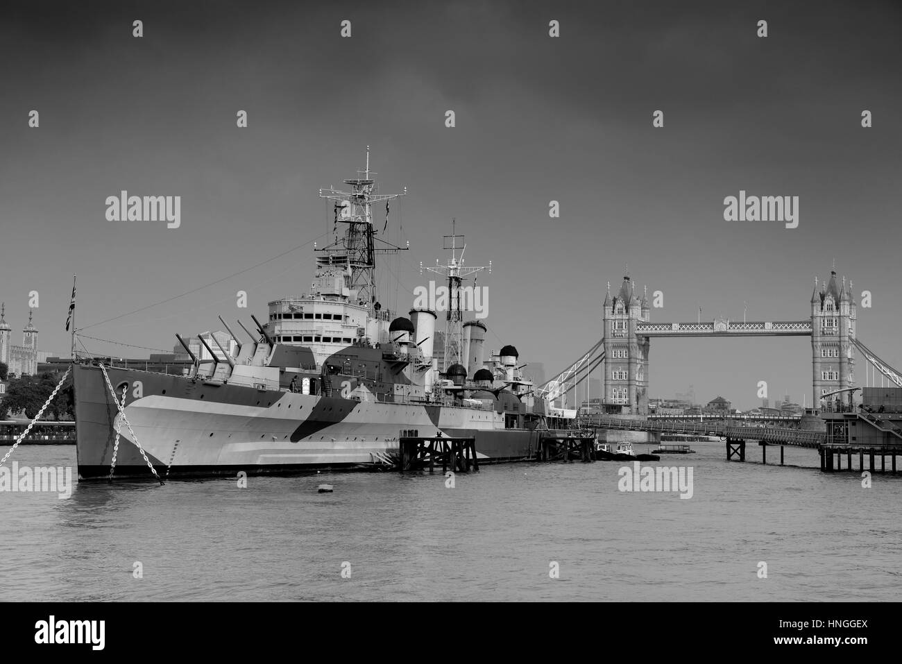 HMS Belfast warship and Tower Bridge in Thames River in London Stock Photo