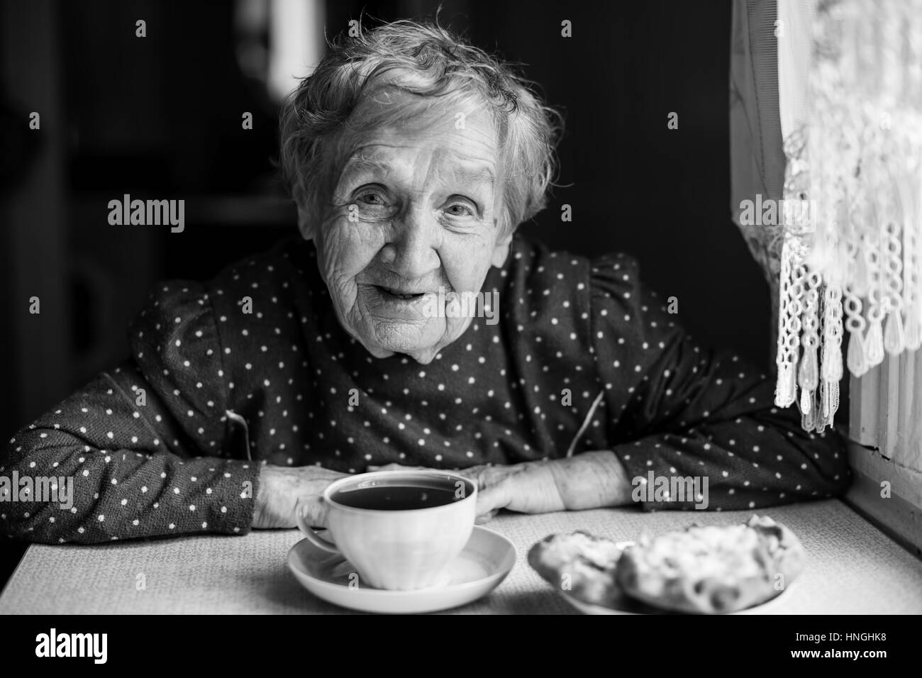 Elderly woman drinking tea. Black and white portrait Stock Photo Alamy