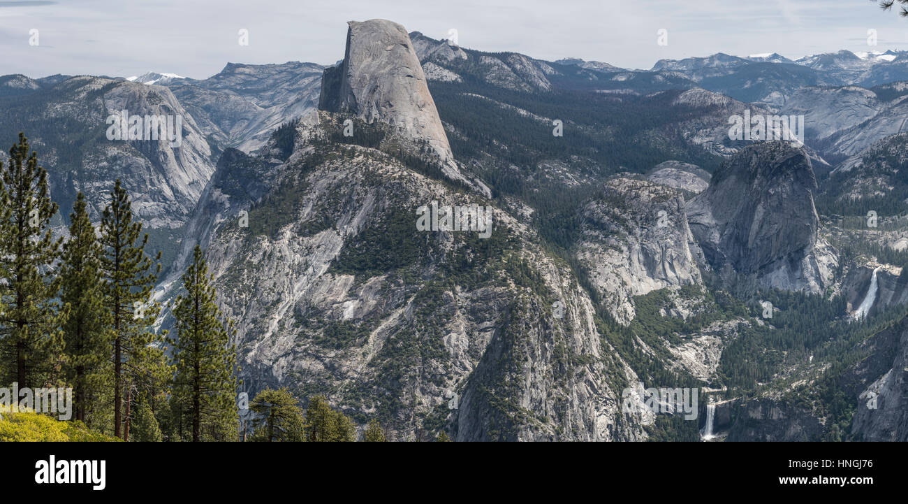 Half dome towers over the landscape at Yosemite National Park in this panoramic view from Glacier Point Stock Photo