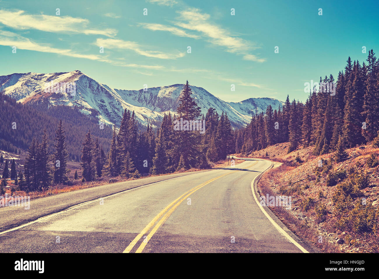Retro color toned Rocky Mountains road, Colorado, USA. Stock Photo