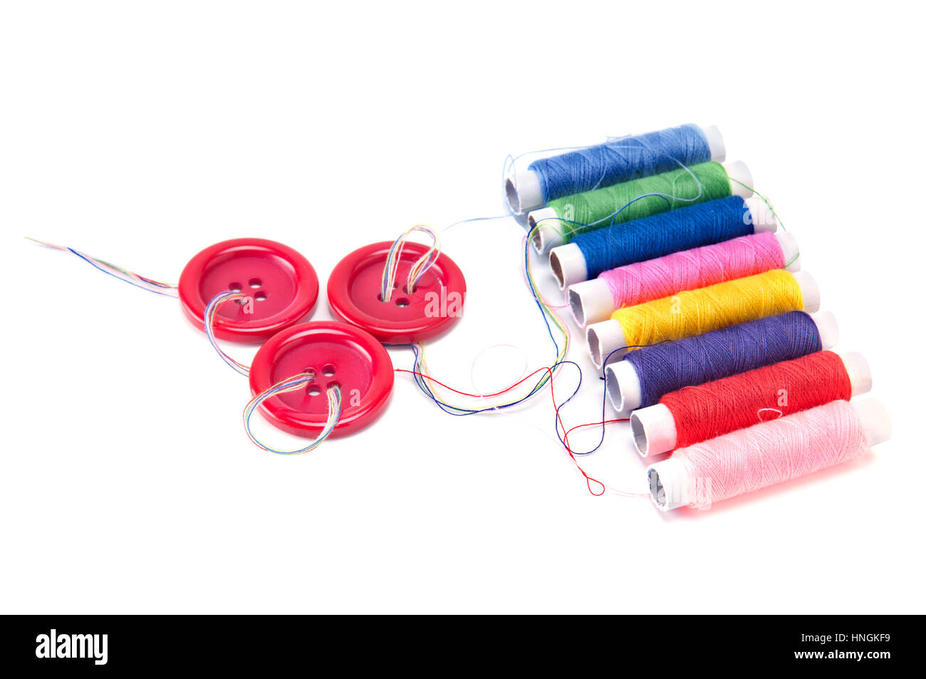 Red buttons and thread spools isolated on white background Stock Photo ...