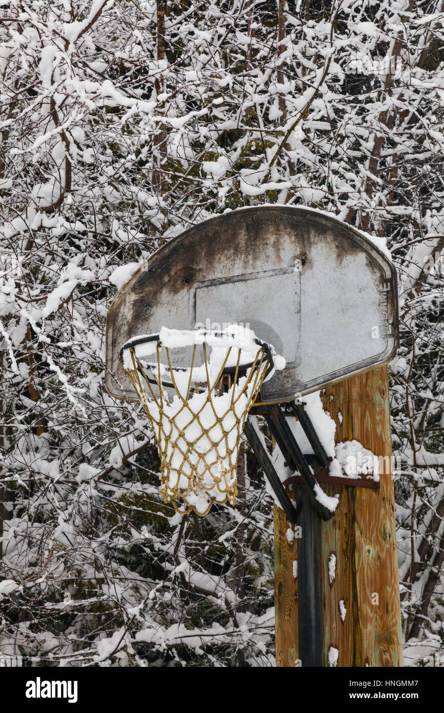 Outdoor basketball net full of snow Stock Photo
