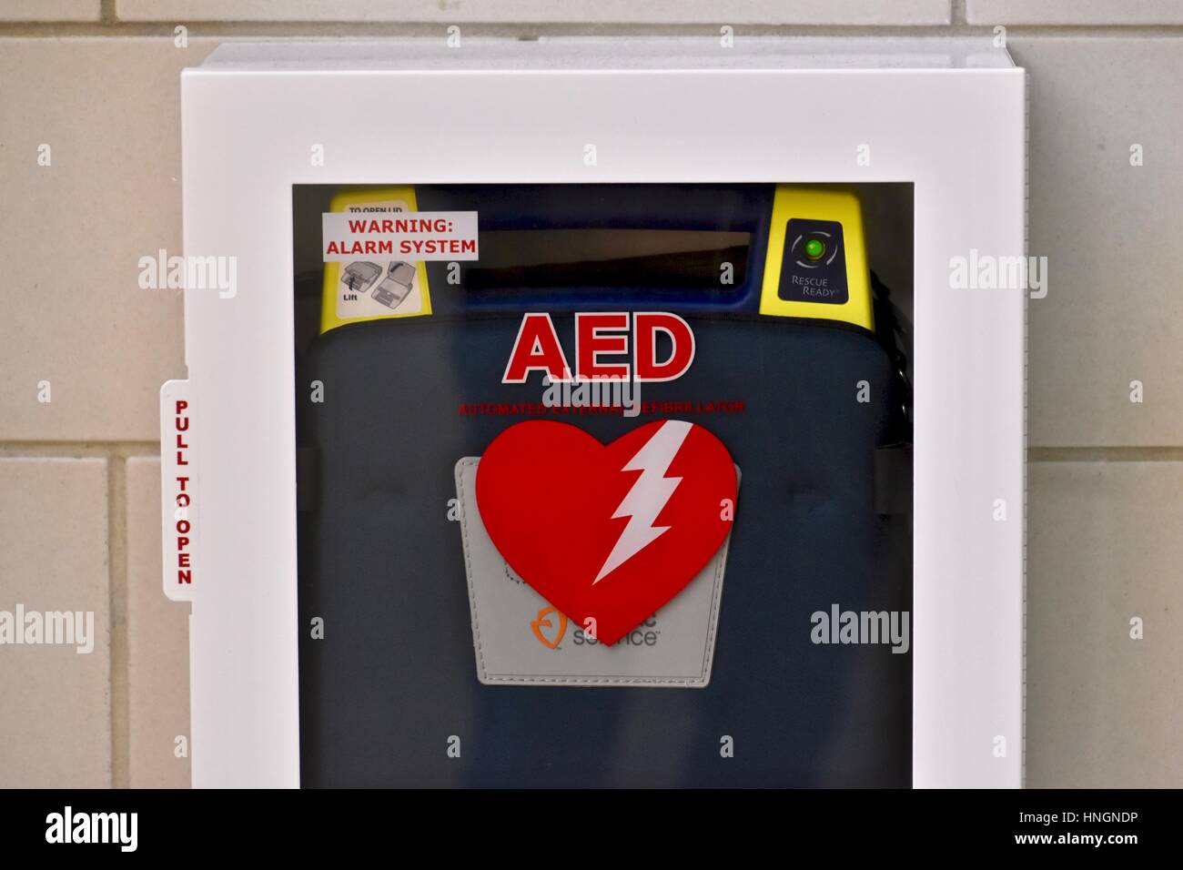 An automated external defibrillator (AED) on the wall of a school Stock Photo