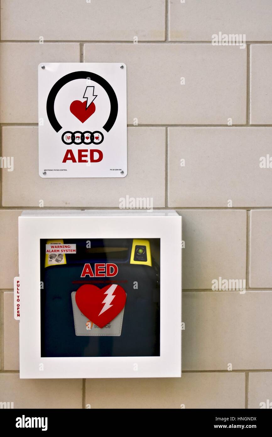 An automated external defibrillator (AED) on the wall of a school Stock Photo
