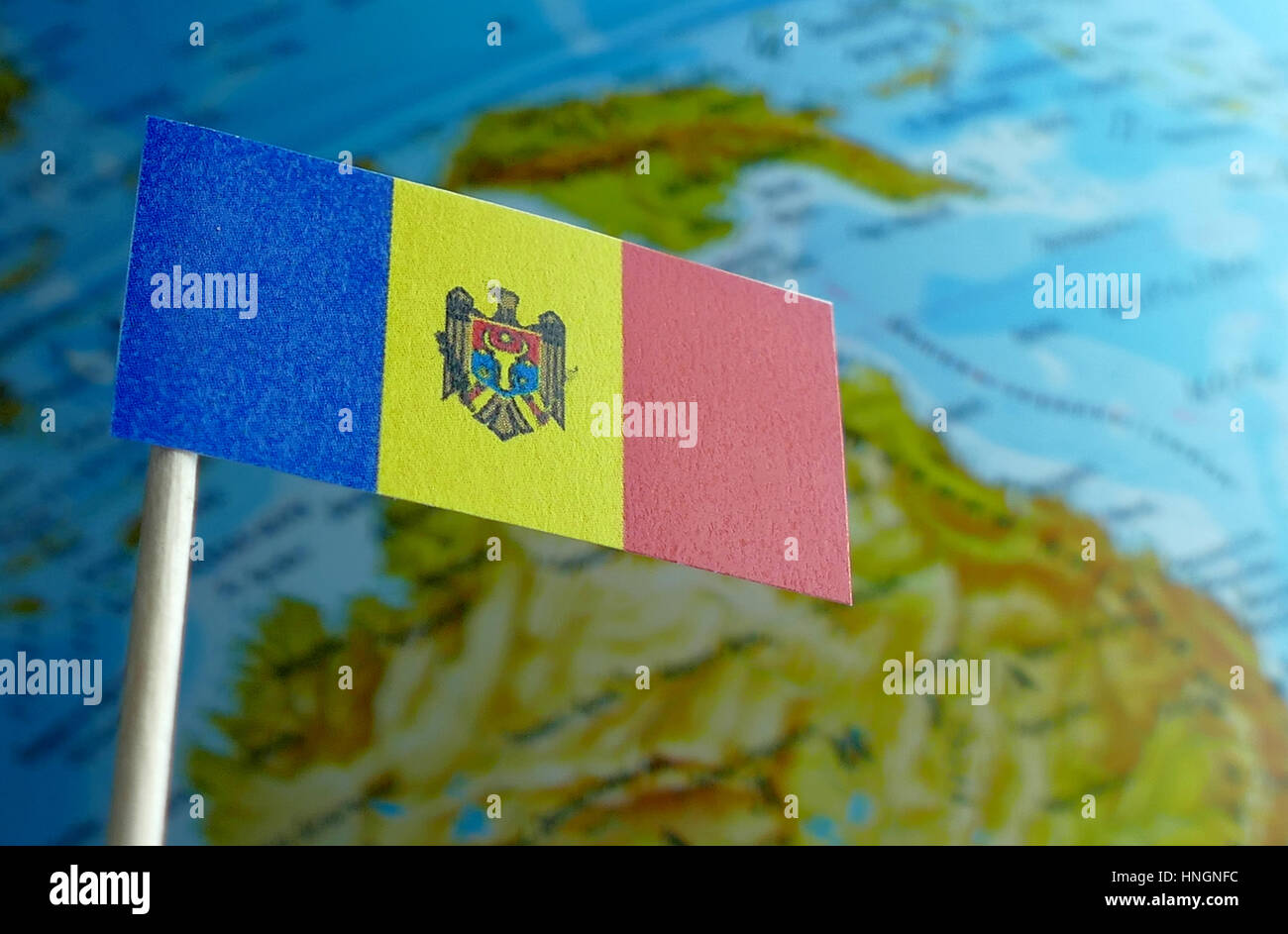Moldova flag with a globe map as a background macro Stock Photo