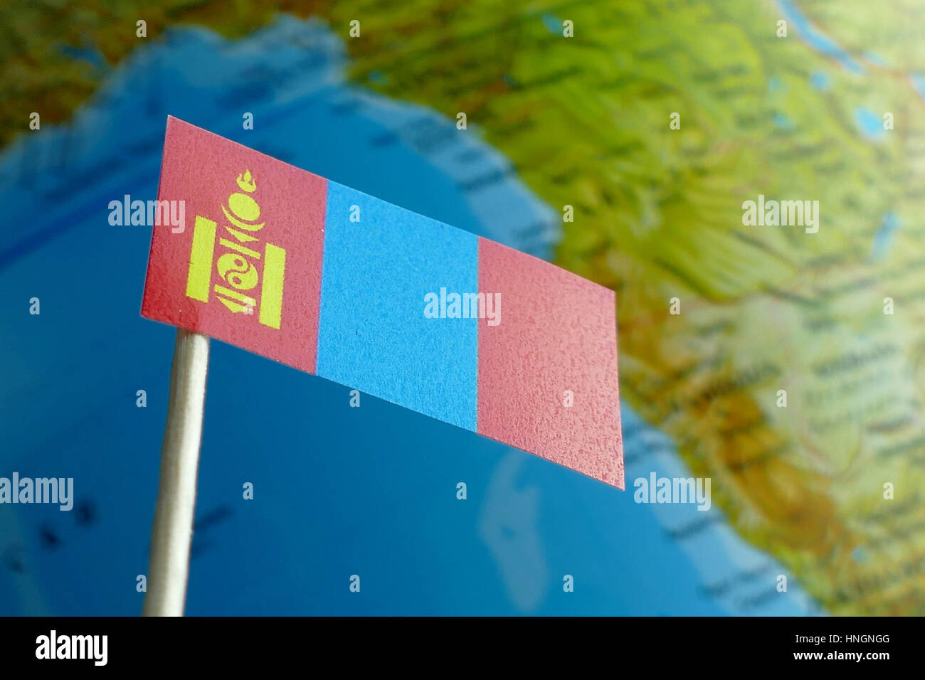 Mongolia flag with a globe map as a background macro Stock Photo