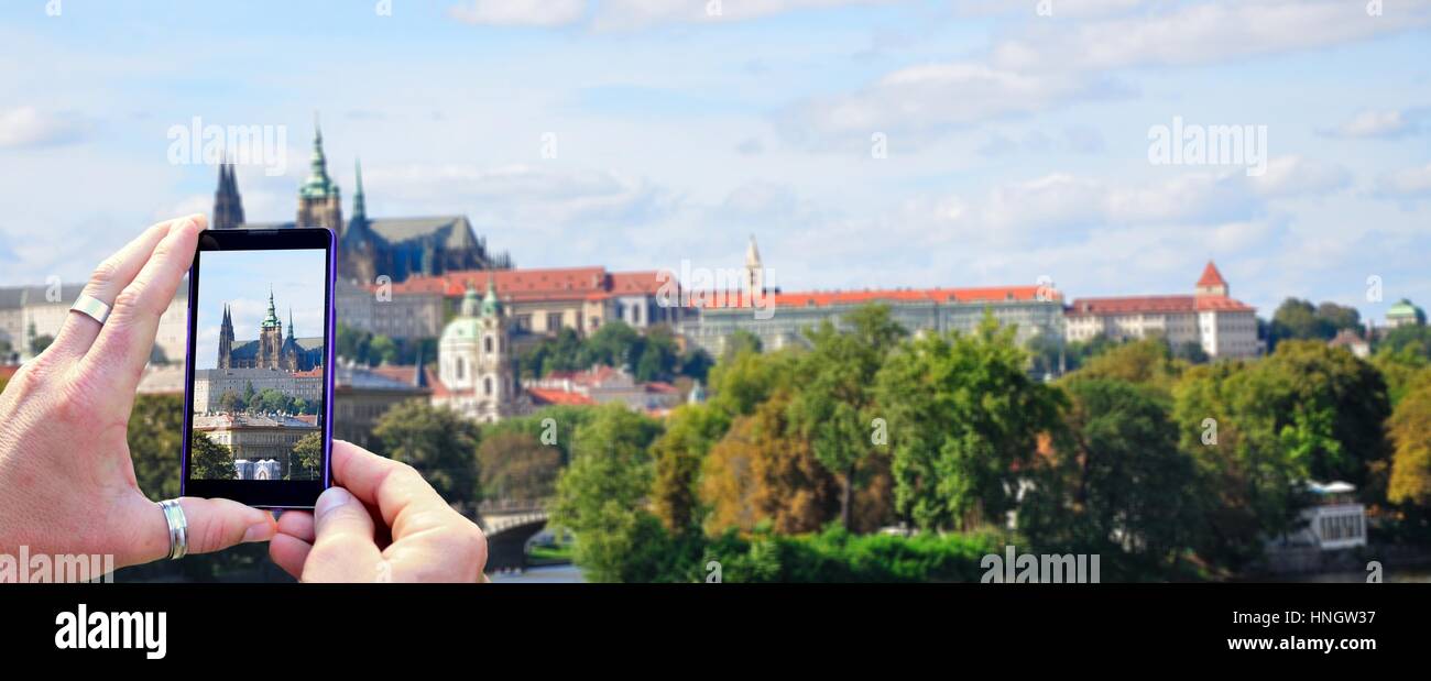 View over the mobile phone display during shooting Prague Castle in