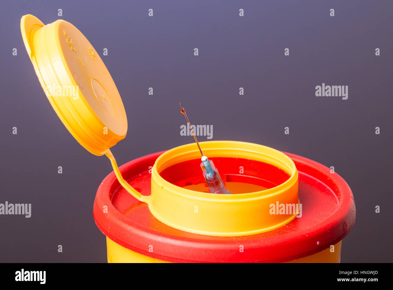 Yellow medical needle disposal waste container, syringe needle with red