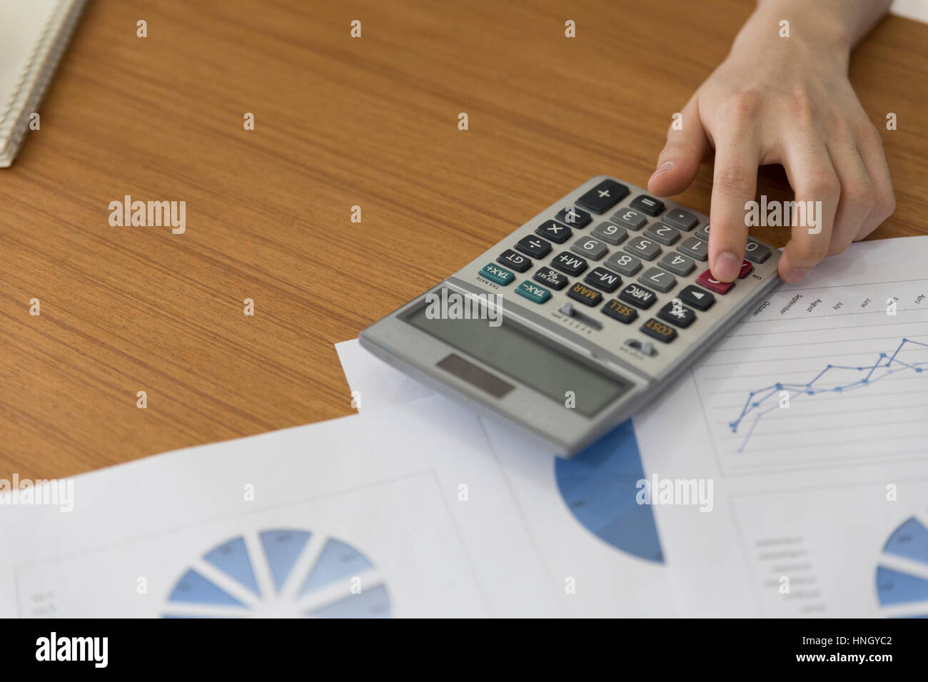 Hand using calculator writing hi-res stock photography and images - Alamy