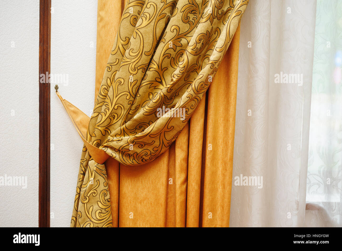 golden curtain on the window in the room Stock Photo