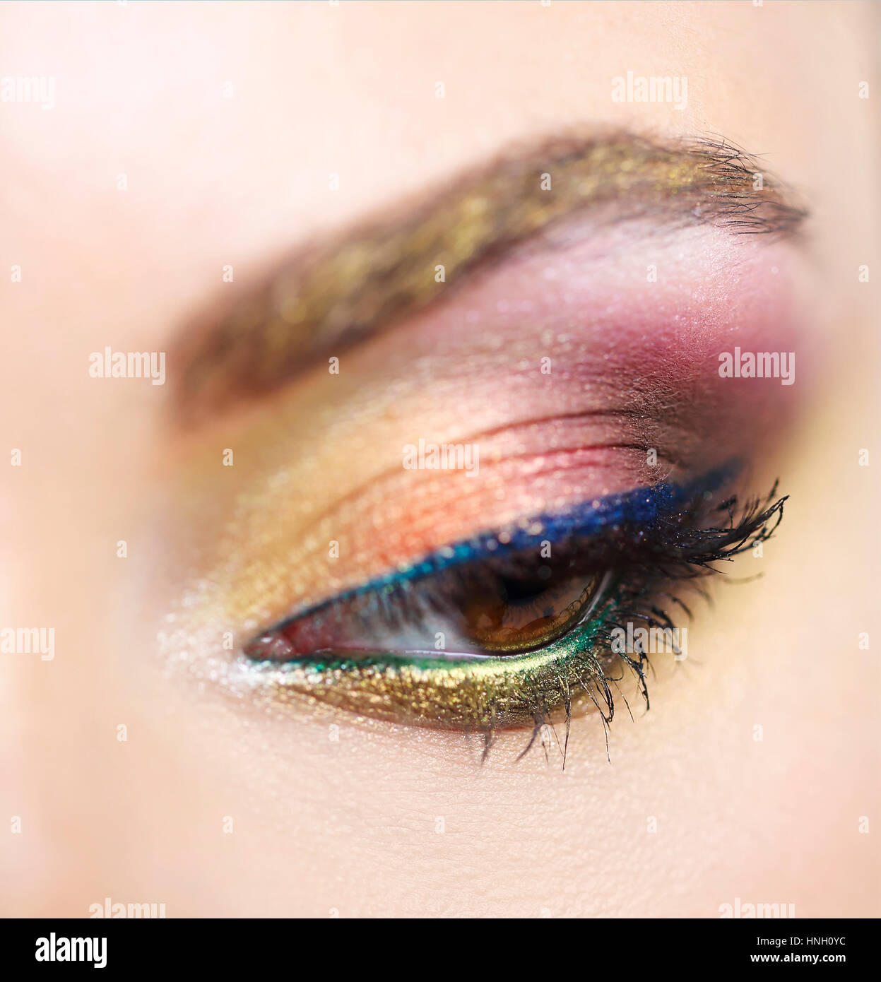 Close up portrait of a beautiful young model with bright make up. Close ...