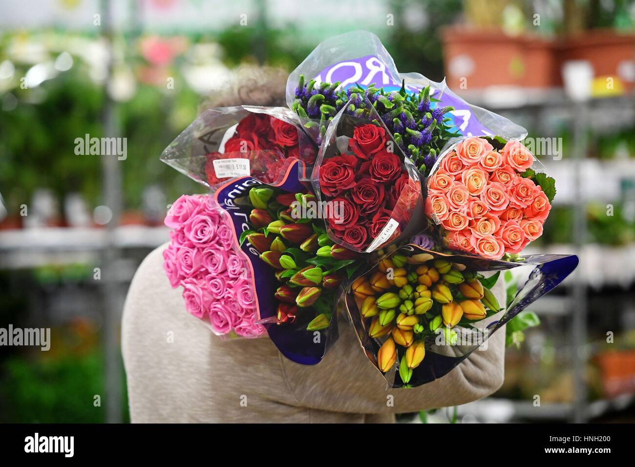 A stall holder stocks up his stall at New Covent Garden Market in London, ahead of Valentine's Day. Stock Photo