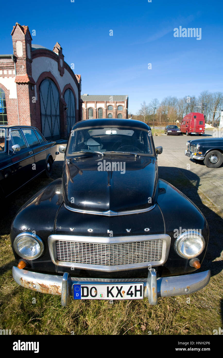 Germany, Waltrop, old Volvo PV 544 car in front of a building of the former coal-mine Waltrop Stock Photo