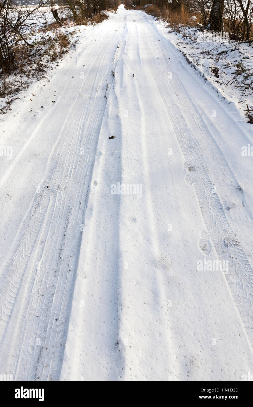 the road in winter covered with snow. Photo closeup. Stock Photo