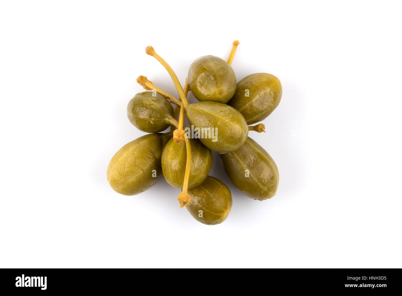 Heap of canned capers on a white background Stock Photo Alamy